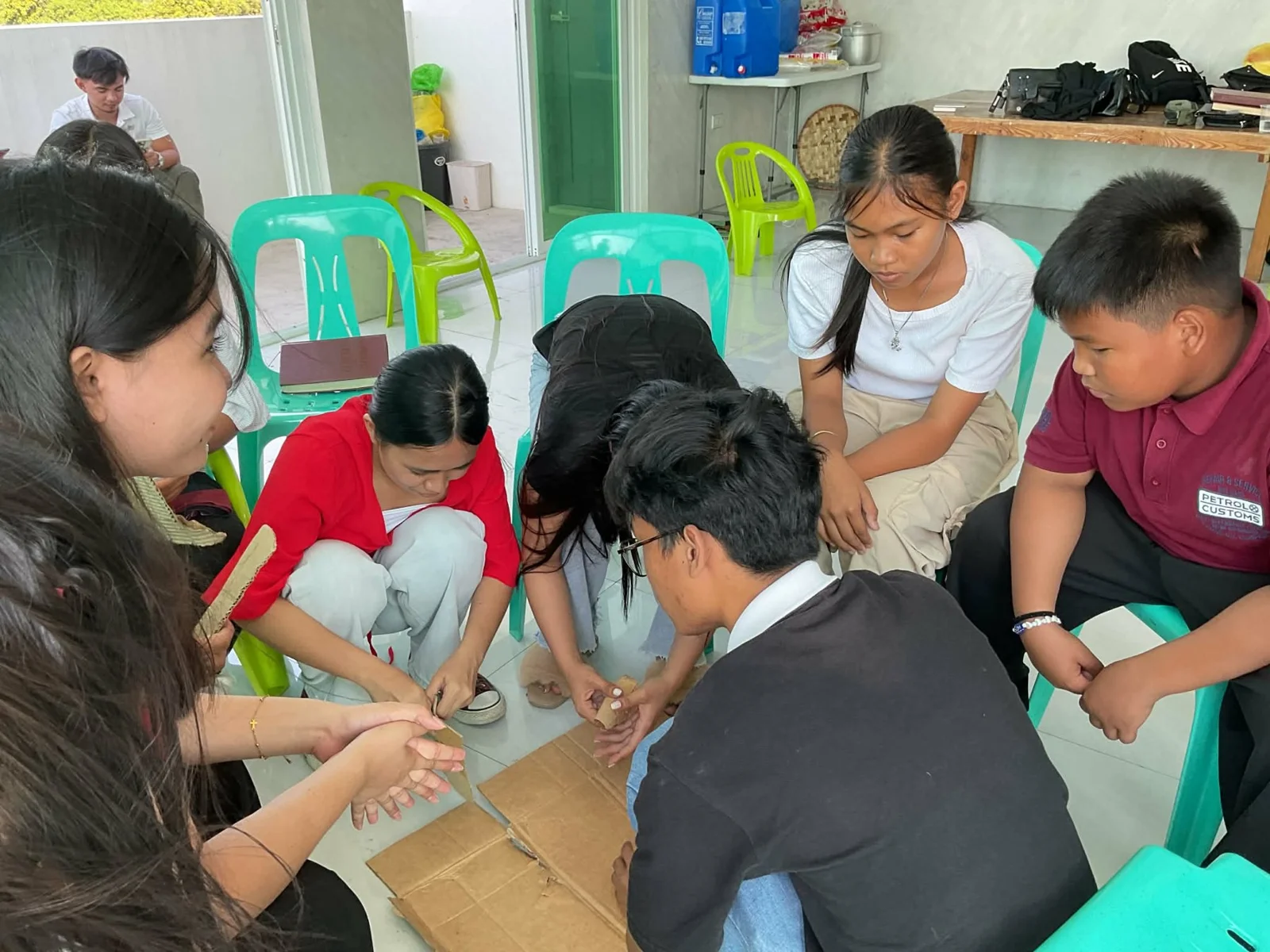 A group collaborating on a hands-on cardboard activity